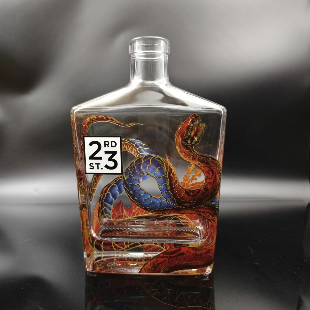 Water slide decal decoration showing intricate metallic graphic design on 700ml square flat spirits bottle