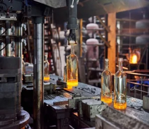 Custom Process High-speed glass bottle manufacturing on an automated production line as part of our custom packaging process