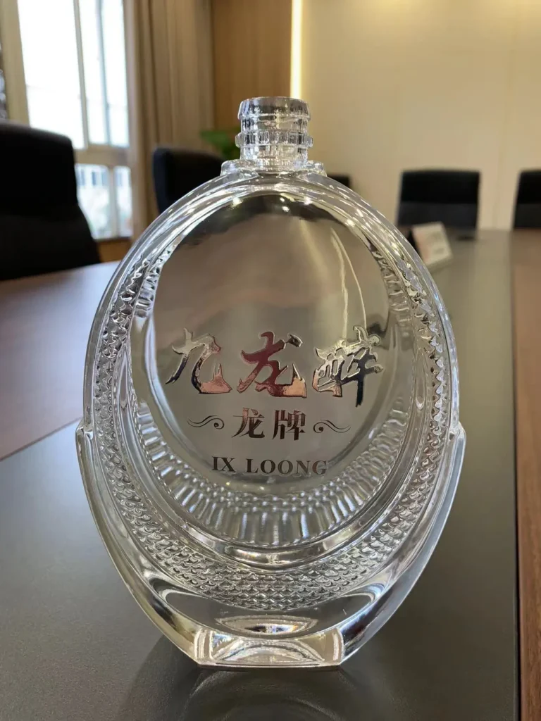 Close-up of a clear glass spirits bottle with intricate side-panel textures and embossed decorative elements, displaying premium transparency and high-precision glass craftsmanship for luxury packaging