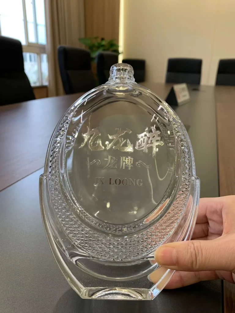 Bespoke ultra-clarity clear super flint glass bottle with fully customized embossed silver foil decal decoration.