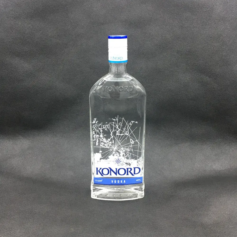 A custom flat rectangular glass vodka bottle with a flask shape, featuring an embossed logo on the shoulder, a thick base, and a highly detailed white and blue silk screen printed nautical map design.
