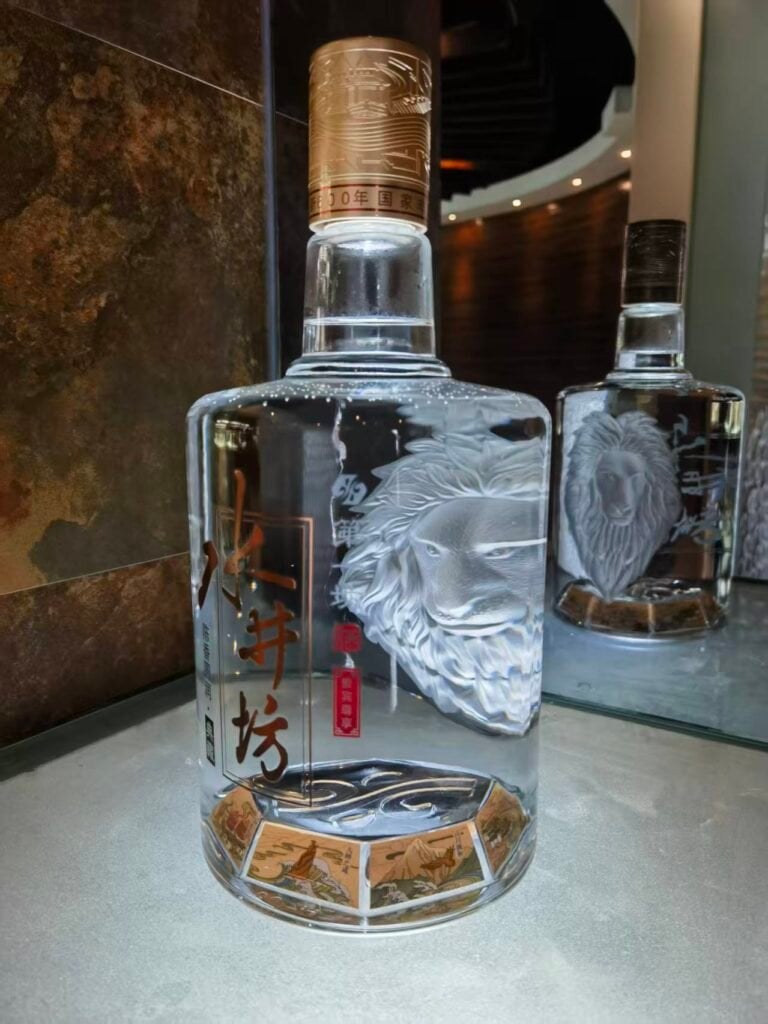 High-end sandblasted glass bottles with intricate engraving for luxury spirits packaging