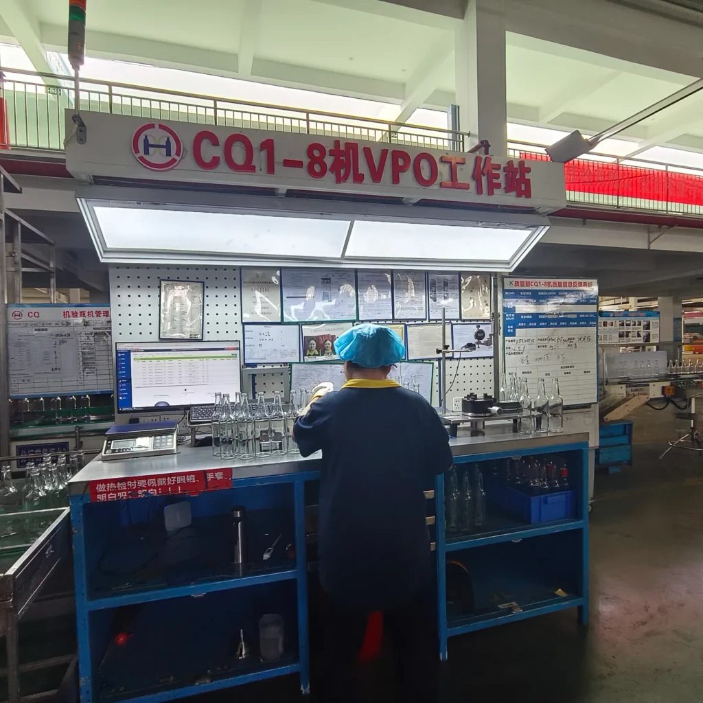 About Us A quality control inspector conducting technical inspections and data logging at a digitized VPO workstation inside a premium glass bottle manufacturing plant, surrounded by glass spirit container samples and defect feedback boards.