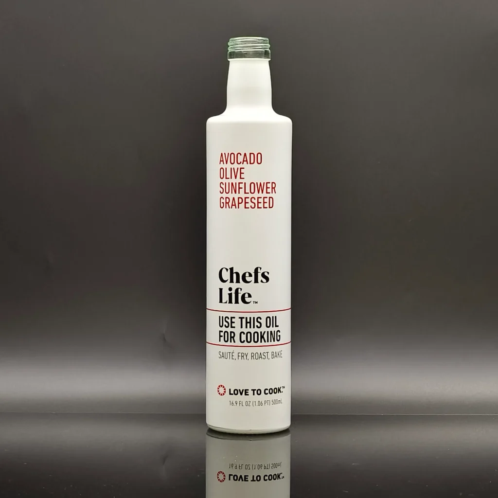 An elegant, solid opaque white coated glass bottle featuring high-definition multi-color silk screen printing with crisp black typography for 'Chefs Life' and vibrant red accents, paired with a matching screw neck finish.