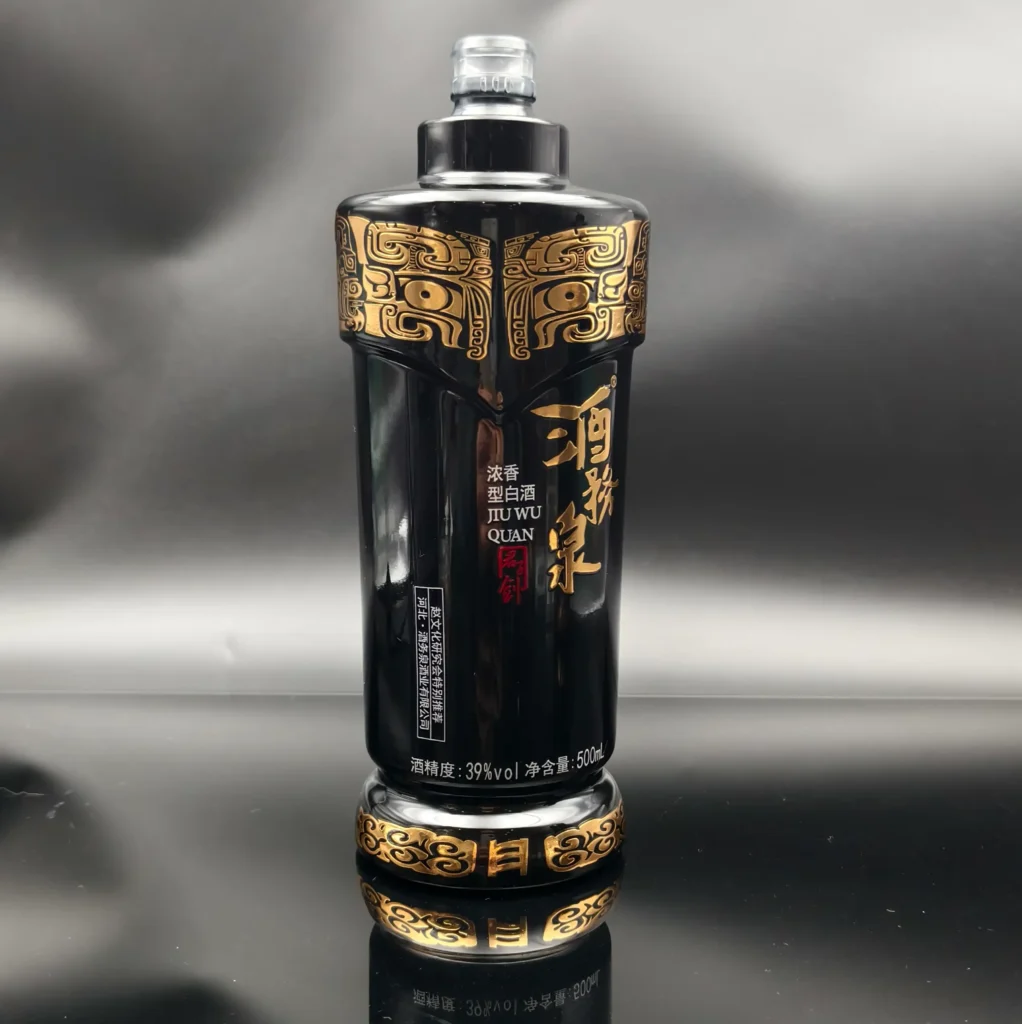 A luxury glossy black spirits bottle showcasing premium metallic gold decoration effects, including intricate embossed tribal patterns, metallic gold lettering, and detailed base accents.